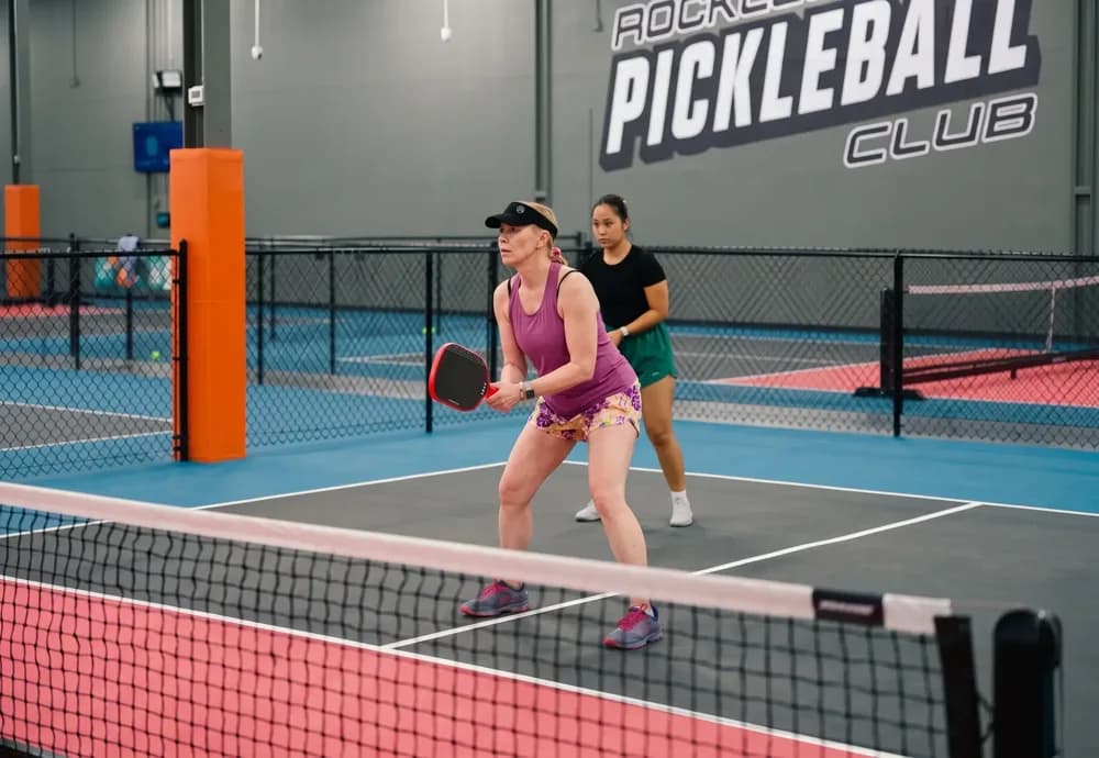 Players rallying on the indoor courts at Rockland Pickleball Club