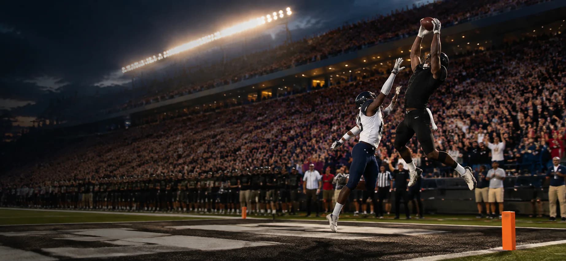 A football receiver making a game-winning touchdown catch over a defender in front of a cheering stadium crowd